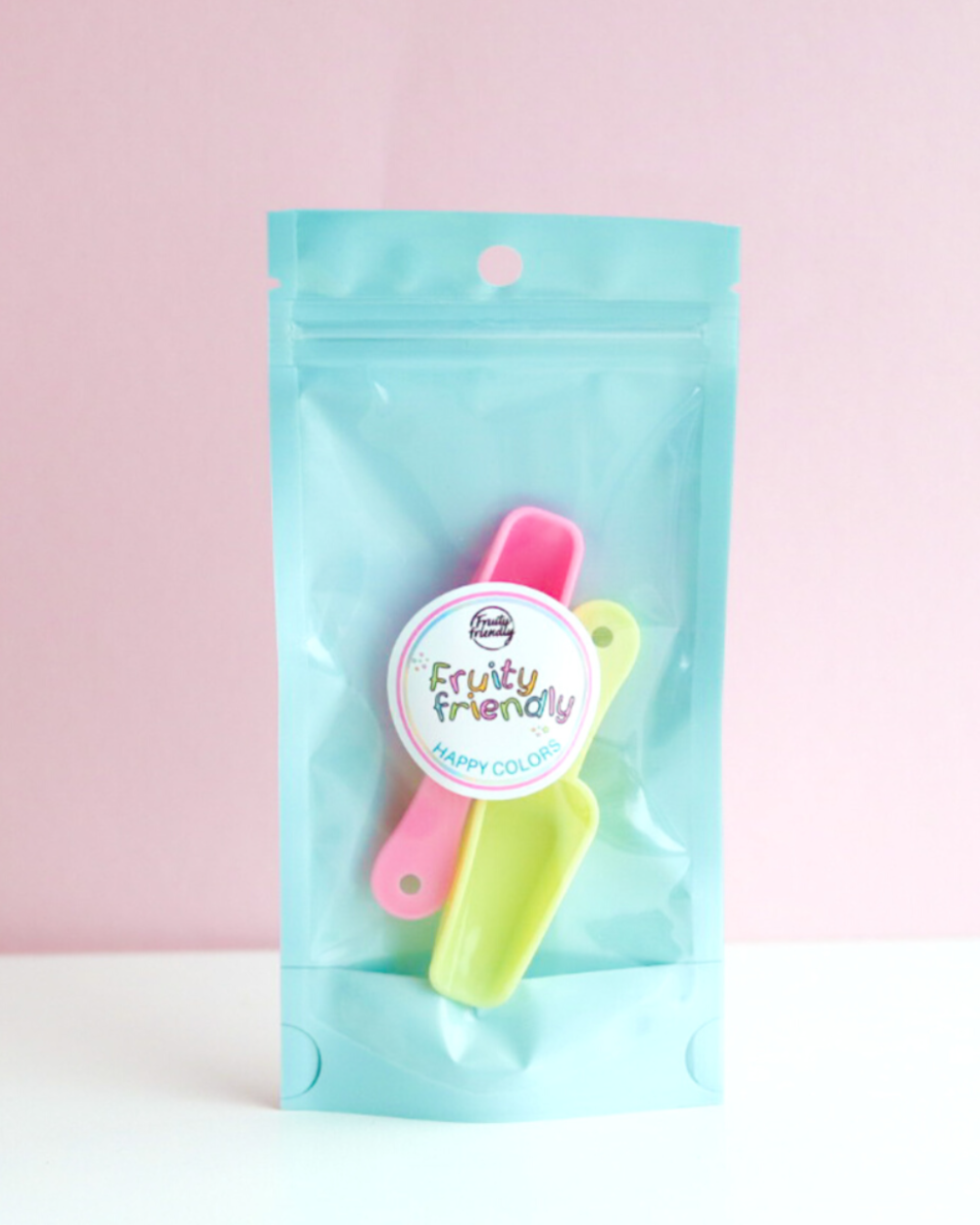 Rosa og gul kakestrøssel-skje